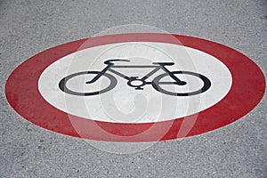 Bicycle riding prohibited symbol on tarred road