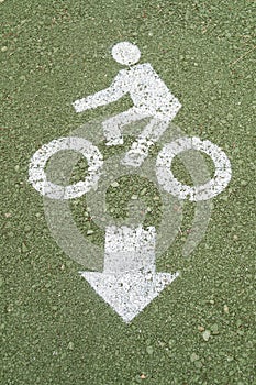 Bicycle road sign on green floor