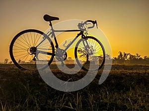 bicycle on rural straw landscape image with Silhouette morning
