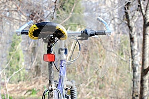 Bicycle saddle with red reflectors, blue bike, outdoor.