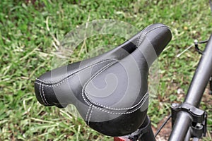 Bicycle seat outdoo close up, curvy and soft saddle is developed for comfort on cross country mountain bike