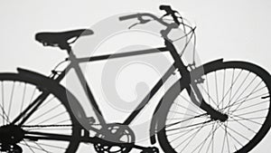 Bicycle shadow on white wall.