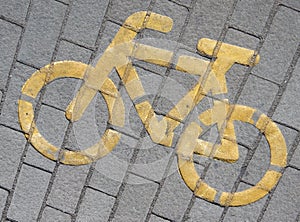 Bicycle sign painted yellow on the pavement photo