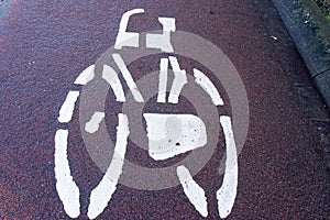 Bicycle sign on red asphalt