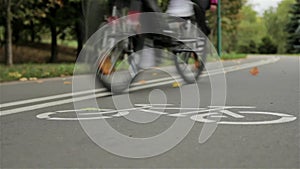 Bicycle sign on the road, bicyclists. Autumn. Close up, zooming slider shot