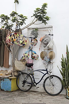 Bicycle standing in front of merchandise in the medina of Asilah