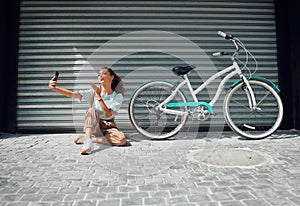 Bicycle, street and woman taking a selfie in a city blowing a kiss in photo or pictures in summer outdoors. Freedom