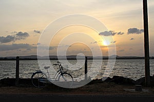 A bicycle and sunset around Bendiwewa Lake in Polonnaruwa