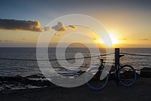 Bicycle sunset cliff ocean.