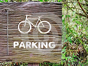 Bicycle Symbol and Parking Text on Wooden Textured Sign Board