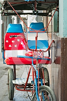 Bicycle taxi in Havana Cuba decorated with American flag