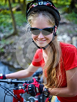 Bicycle teen with ladies bikes in summer park. Womens road bike for running.