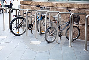 Bicycle top tubes are securely chained, by chain links and locks, to the metal bike racks. Outdoor Activity, Exercise, Sport,