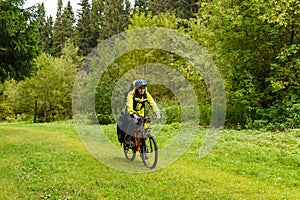 Bicycle tourist in the autumn forest