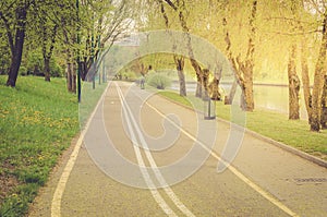 Bicycle track in the park along the river/bicycle track in the park along the river in sunny day