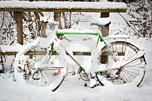 Bicycle under pack of snow