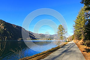 Bicycle and walking path along the Achensee Lake during winter i