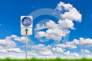 Bicycle way sign on fresh spring green grass