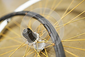 Bicycle wheel and airless tire disassembled on the floor of a bike repair shop