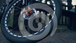 Bicycle Wheel Close-up, Smooth Camera Movement. Details of a Bicycle Standing in the Forest. Concept of Cycling and