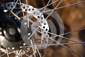 Bicycle wheel with elements closeup: disc brakes, spokes, reflector.