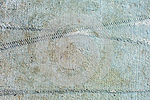 Bicycle wheel footprint in old dirty dried concrete. Bike tire imprints left in cement after bicyclist rode bike through freshly