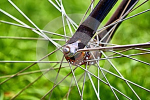 Bicycle wheel with hub close up on the grass background