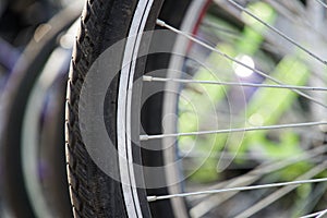 Bicycle wheel in a row close-up wheel detail, bicycle spoke.