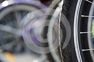 Bicycle wheel in a row close-up wheel detail, bicycle spoke.