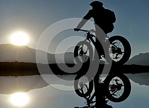 Bicycler on clear lake