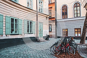 Bicycles on an empty Scandinavian cobblestone street, a cozy courtyard with historic buildings, old facades with