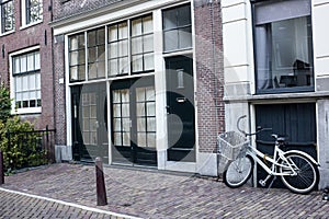 Bicycles and flowers in Amsterdam Holland Netherlands near famous UNESCO world heritage canals Singel with typical dutch