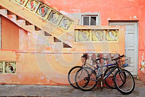 Bicycles on grunge tropical Caribbean facade