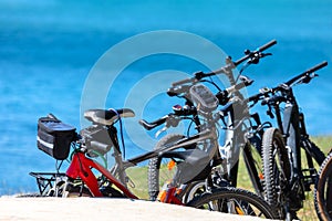 Bicycles parked on the beach by the sea