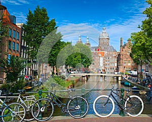 Bicycles parked in a bridge across the canal in Amsterdam, Netherlands