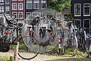 Bicycles parked on a bridge in Amsterdam, The Netherlands. A lot of parked bikes on the pavement.
