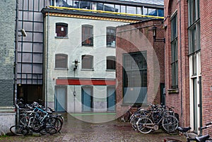 bicycles parked in front of buildings during rainy day