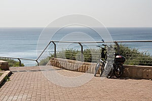 Bicycles are parked on the waterfront at the descent to the sea