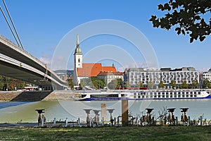 Bicycles for rent on the foreground, bridge and Saint Martins cathedral on the background, the river Danube, Bratislava