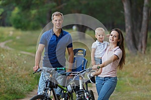 Bicyclist family, leisure in pine forest