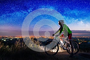 Bicyclist with mountain bike on top of the hill