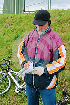 The bicyclist on rest considers a book