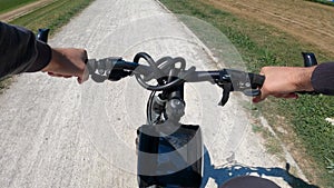 Bicyclist riding a bicycle in the city park, POV point of view