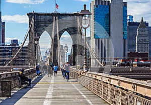 Bicyclists and pedestrians crossing empty Brooklyn Bridge during the coronavirus COVID-19 pandemic lockdown in New York City