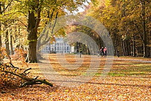 Bicylists near Groeneveld Castle in autumn, Netherlands