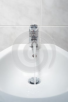 Bidet with running water front shot.