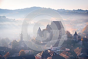 Biertan, Transylvania. Autumn sunsrise landscape with medieval saxon fortified church in Romania