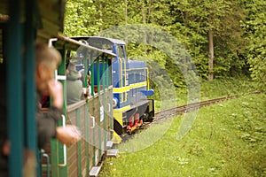 The Bieszczady Forest Railway. A view of a locomotive pulling wagons in the forest