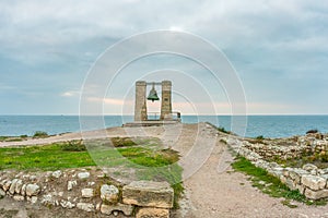 Big alarm bell. The ruins of ancient Greek city of Chersonesus Taurica in the Crimea peninsula under the cloudy sky