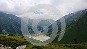 Big Almaty lake in the mountains. Green hill.